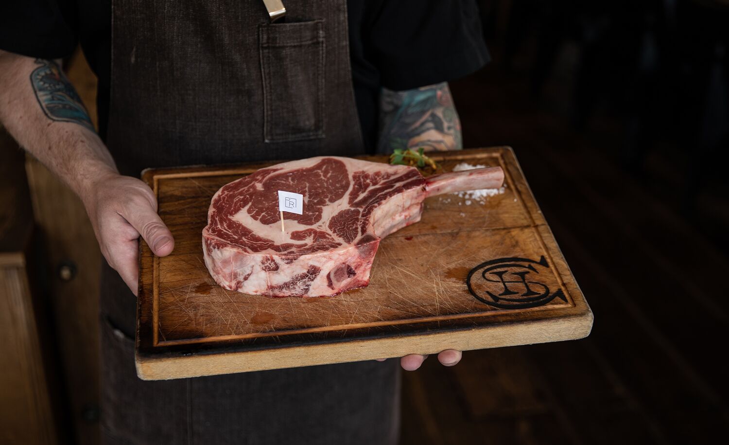 A delicious steak on a wooden cutting board at Chuck's Steakhouse in Banff, Canada.